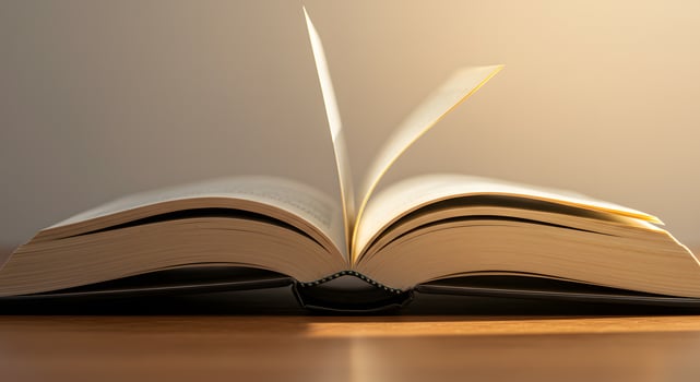 An open book with a light shining on it photo