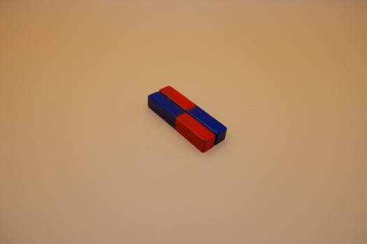 Two Red and Blue Rectangular Magnets on Minimalist Background photo