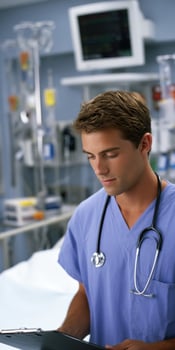 Young healthcare professional reviewing patient records in a hospital setting photo