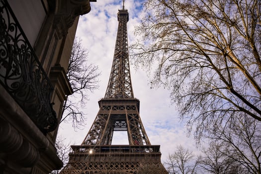 Eiffel Tower Against Bright Winter Sky with Parisian Architecture photo