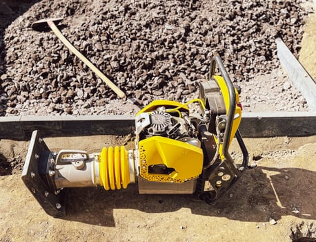 Small plate compactor, vibratory hammer, jumping jack machine, power tool at construction site photo