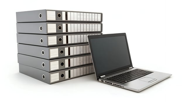 Stack of Ring Binders with Laptop on White Background photo
