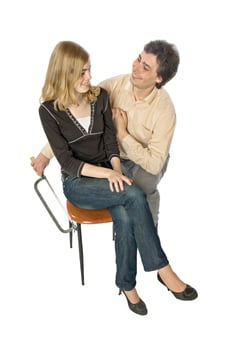 Humorous photo of a man sawing off a leg of woman's chair