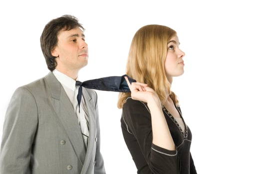 Young woman pulling a man by a necktie, over white photo