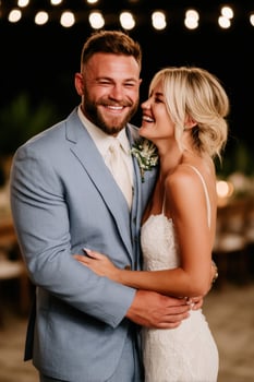 Joyful couple celebrates their wedding under string lights photo