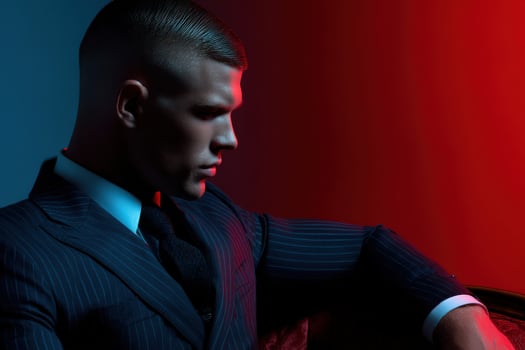 Stylish man in tailored suit with dramatic lighting photo