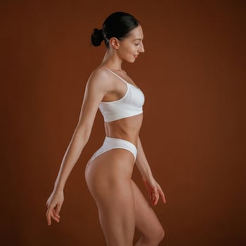 New, underwear collection. Woman, with ,slim body shape is posing against background photo