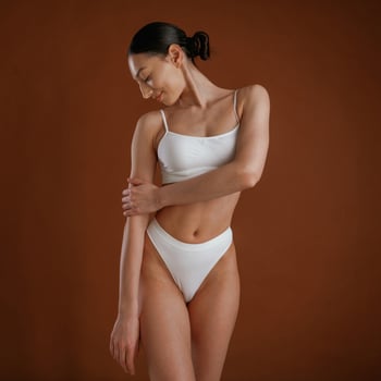 Showing,brand ,,new underwear. Woman with slim body shape is posing against background photo