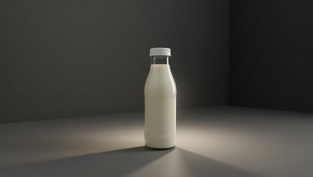 A bottle of milk on a table in front of a dark wall photo