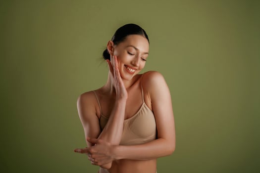 Smiling, cheerful, facial expression. Woman with slim body shape is posing against background photo