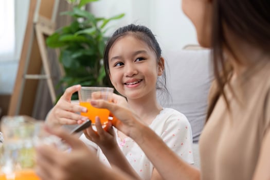 Wellness through healthy eating. Mother and daughter enjoying fresh juices photo