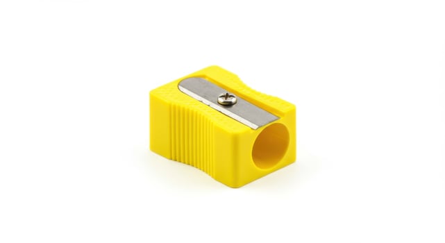 Yellow Plastic Pencil Sharpener on White Background photo