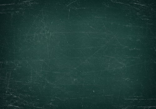 Dark green chalkboard surface with scratches. Texture of a school board with grunge effect. Abstract background with traces of chalk and wear. photo