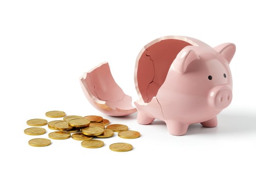 Broken piggy bank with gold coins on white. Financial crisis, economic problem, bankruptcy, money loss, investment risk and savings concept. Studio shot. photo