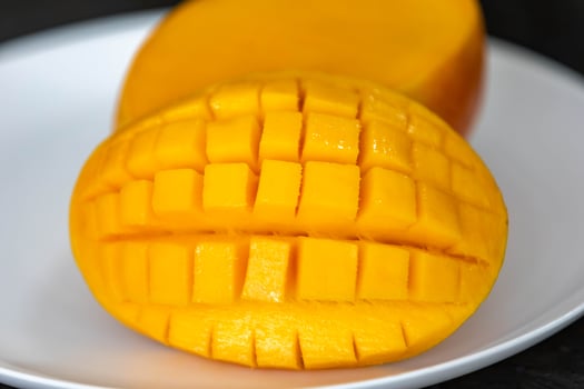 Ripe rosa mango isolated on uniform background. Brazilian fruit and food delitious photo