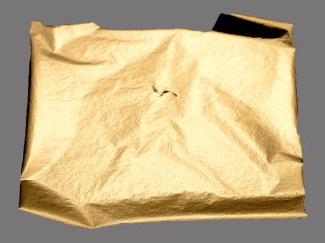 Golden foil textured folds with warm, soft light and subtle shimmer. Gilded, crumpled paper piece photo