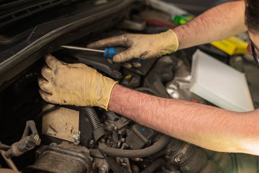 hands of a mechanic repairing the engine of a diesel car in a mechanical workshop photo