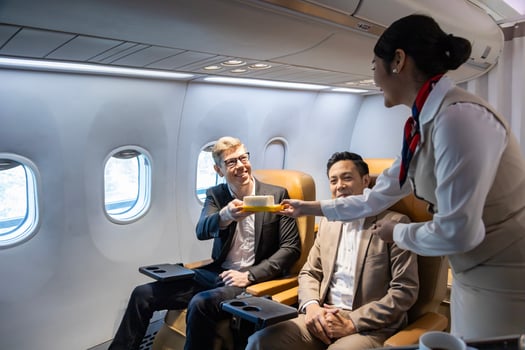 Flight attendant is serving food to the customer for in flight meal, airline travel and transportation photo