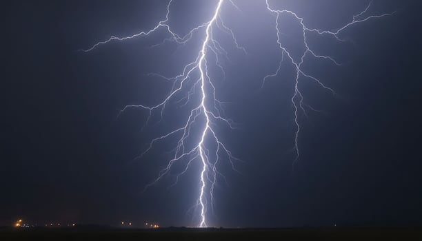 bolt of lightning striking across a dark sky photo