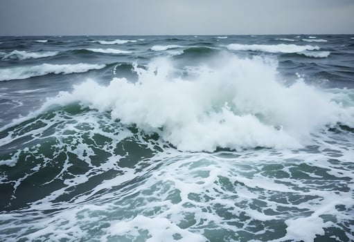 large body of water with waves coming in photo