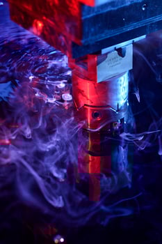 vertical view of the machine working on liquid with blue and red illumination photo
