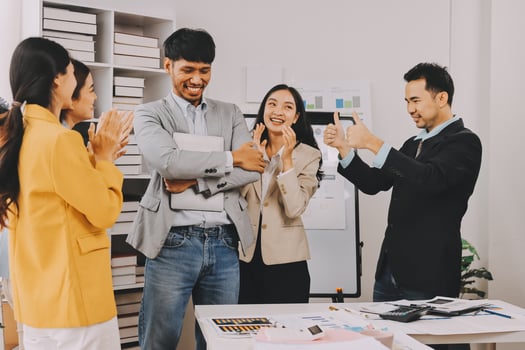 Business people clapping and smiling in an office photo