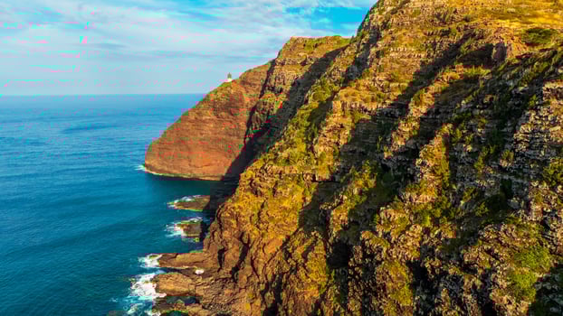 Stunning unapproachable rocks descending into the ocean. photo