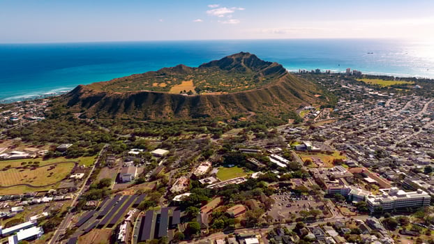 Modern urban area around the spectacular mount. Beautiful cityscape of Honolulu at the foot of Diamond Head Crater. Aerial view. photo