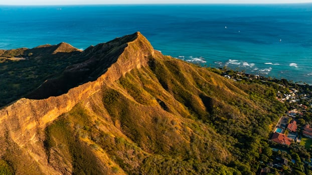 Diamond Head Crater descending to the waterscape. Endless blue of the Pacific Ocean at backdrop. photo