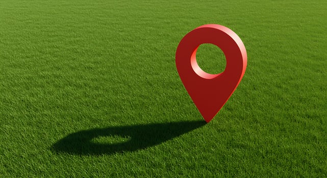 A red pin on a green field photo