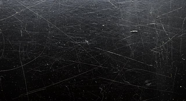 A black metal surface with scratches photo