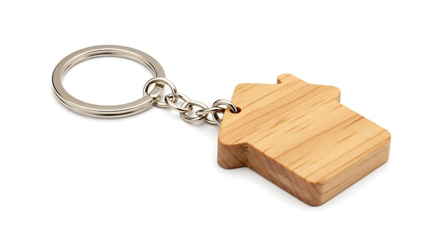 A wooden keychain with a house shape on it photo