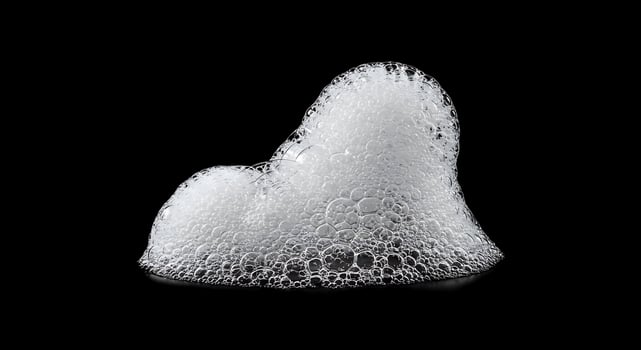 A white foam sculpture on a black background photo