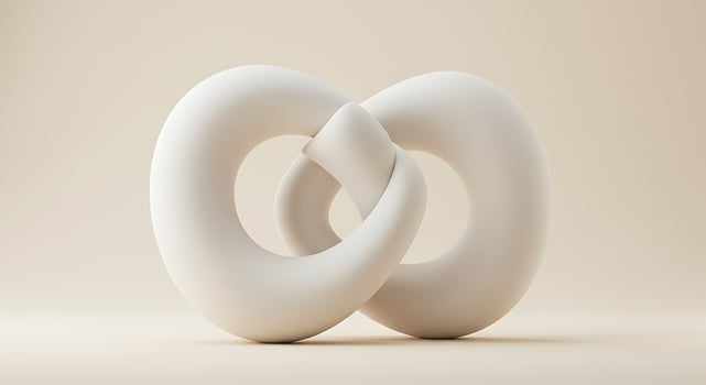 A white sculpture of two intertwined rings photo