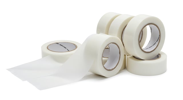 A roll of white tape with a white adhesive photo