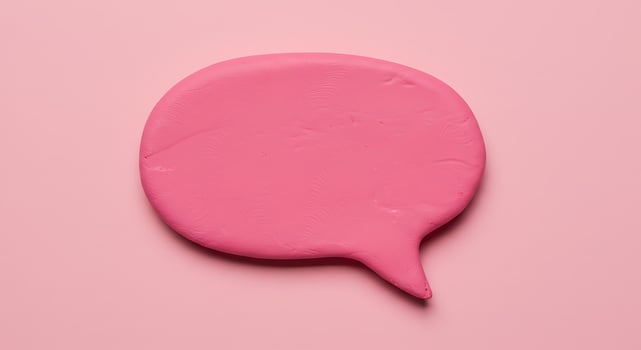 A pink speech bubble on a pink background photo
