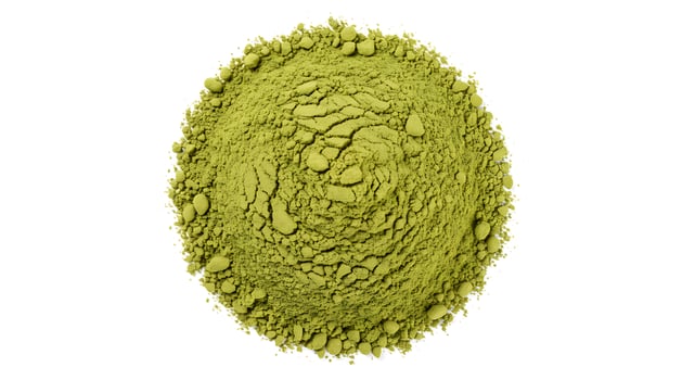 A green powder is shown on top of a white background photo