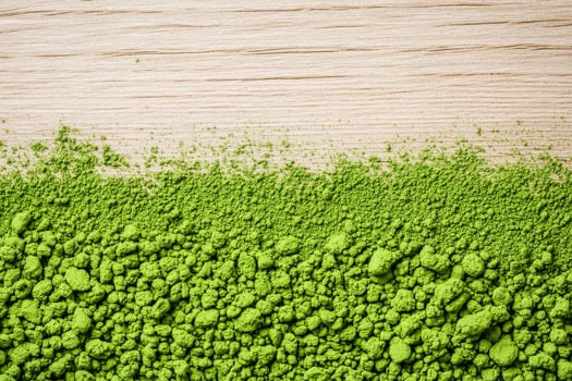 Matcha green tea superfood concept. Lush green texture against a wooden background. photo