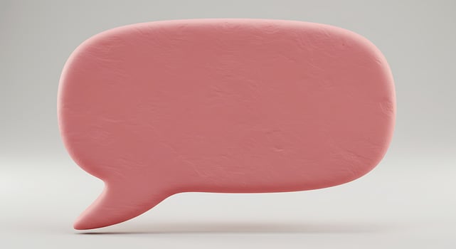 A pink speech bubble on a white background photo