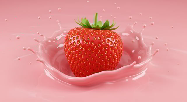 A strawberry is being splashed with pink liquid photo