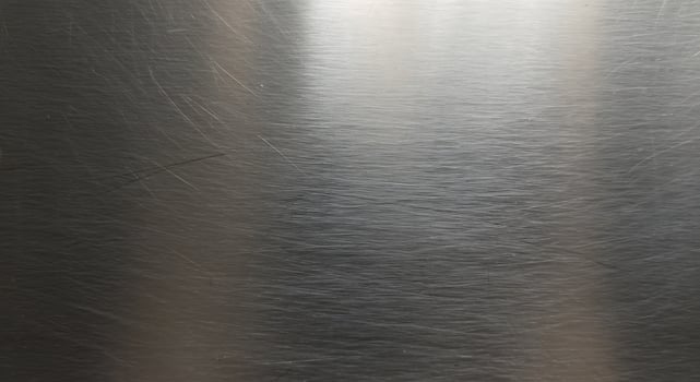 A close up of a metal surface with a shiny finish photo