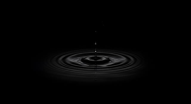 A black and white photo of a drop of water