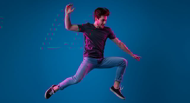 A man jumping in the air on a blue background photo