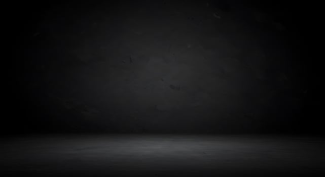 Dark room with concrete floor and black walls photo