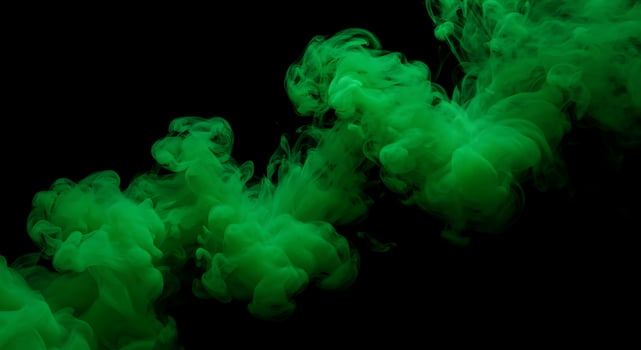 Green smoke is being sprayed into the air photo