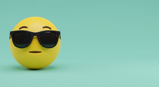 A yellow egg with sunglasses on a green background photo