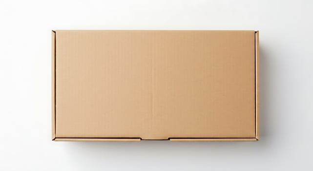 An empty cardboard box on a white surface photo