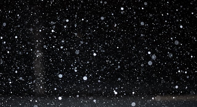 A person standing in the snow at night photo