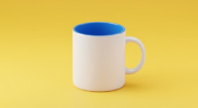 A white mug with blue rim on a yellow background photo