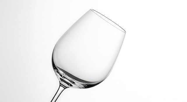 A wine glass is shown on a white background photo